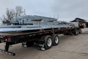 steel beams tied to flatbed transport, steel coating Buffalo, NY